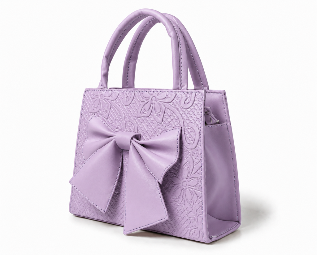 MAGNOLIA - Bolsa mini de doble asa con moño al frente y delicado grabado floral.