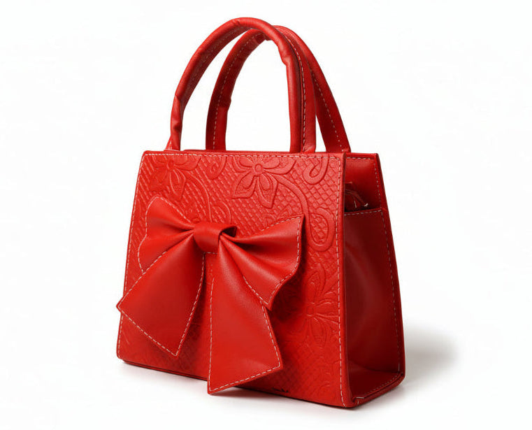 MAGNOLIA - Bolsa mini de doble asa con moño al frente y delicado grabado floral.